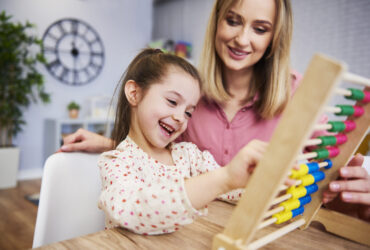Girl and teacher using an abacus during homeschooling